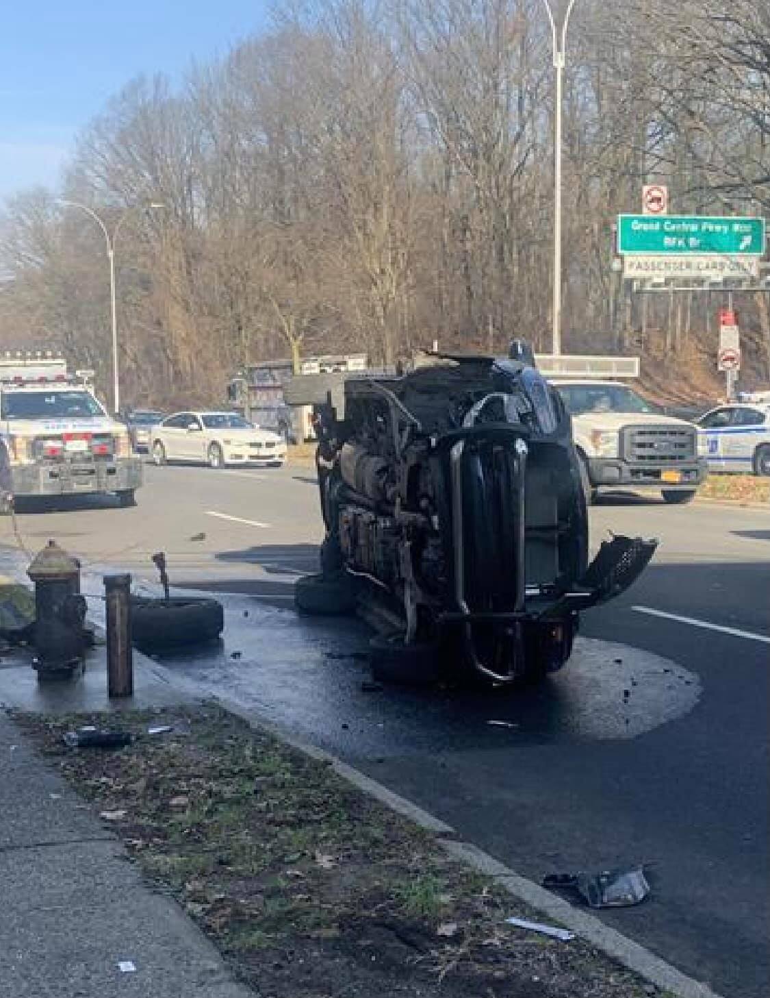 Vehicle flipped with entrapment by the service road of Grand Central Parkway in Queens.