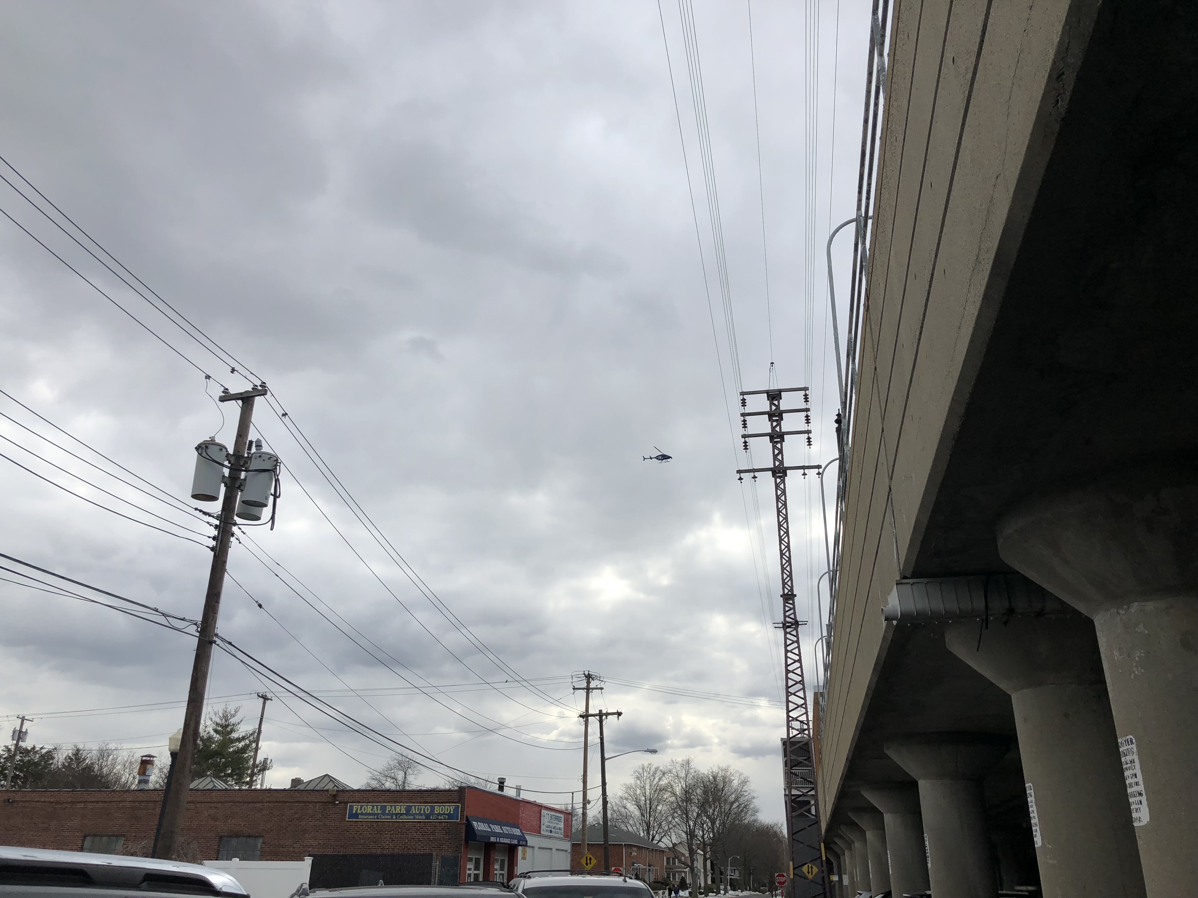 Chopper hovering above a funeral home for fallen member of FDNY in Floral Park.